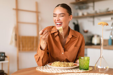Italian inspiration. Happy european woman enjoying freshly cooked pasta, holding fork and smiling,...
