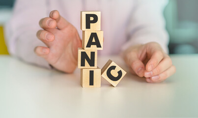 Word panic on wooden cubes with reflection on wooden background