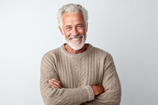 Portrait of a smiling senior man standing isolated on a white background