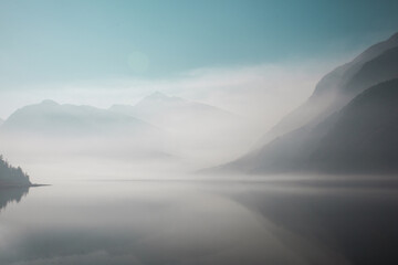 Fototapeta na wymiar Hazy mountains and a lake from BC wildfire smoke