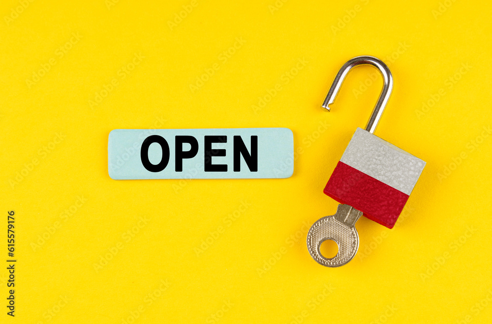 Aufkleber On the yellow surface is an open lock with a key and a sticker with the inscription - open