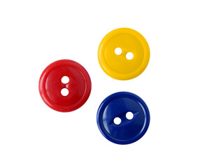 Three red blue and yellow plastic sewing buttons isolated cutout on transparent