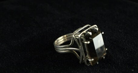 Silver vintage ring with large smoky quartz on spinning velvet display case.