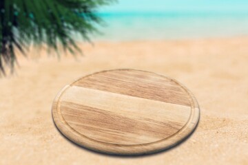 Wooden blank pedestal at beach sand.