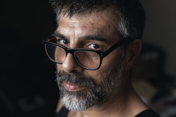 Dark Mystery: Captivating Portrait of a Dark-Haired Man with Glasses and Beard