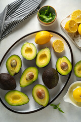Whole and sliced avocado, cooking guacamole, top view.