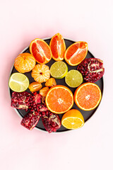 Many mixed fruits on white plate, top view