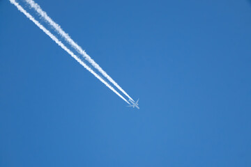 Jet contrails across the bright blue sky