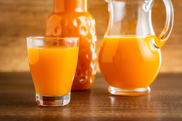 A glass of fruit juice. Orange  juice on wooden table.