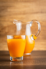 A glass of fruit juice. Orange  juice on wooden table.