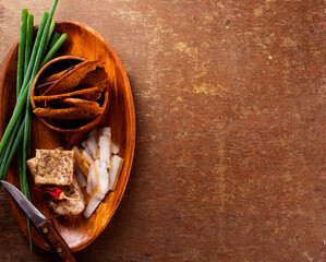 Pork fatback with spices, rye bread and green onion on wooden table