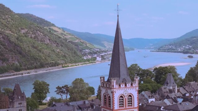 Grape Escape Rhine Valley, medieval German Bacharach city, Old Post Compound With Postenturm, wide waters of Rhine River, slate roofs of old half-timbered houses, wine tourism in Rhineland-Palatinate