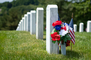 Patriotic flowers and American flag decoration white marble gravestones
