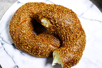 Traditional turkish breakfast with simit bagels on marble cutting board