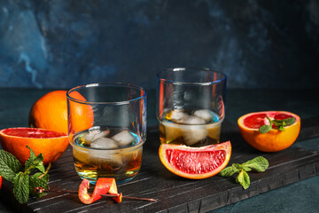 Glasses of rum with ice, mint and Sicilian orange on table