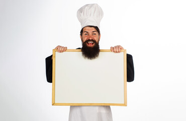 Smiling male chef with empty whiteboard. Cook showing billboard with copy space for text. Chef menu. Master chef, baker or cook with blank poster for advertising healthy menu. Cooking, culinary, diet.