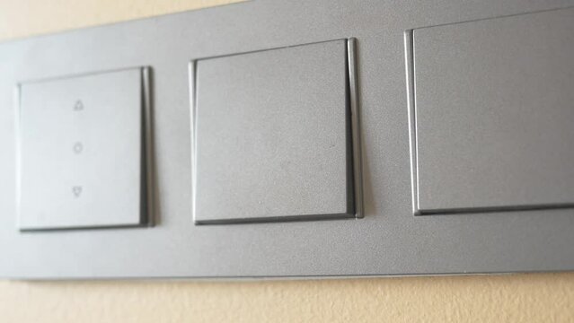 A finger turning on lighting switch .