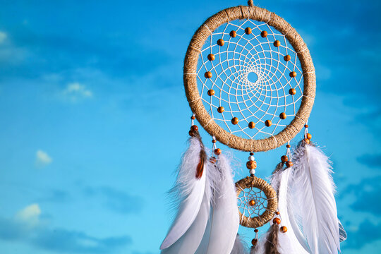 Beautiful dream catcher hanging against blue sky