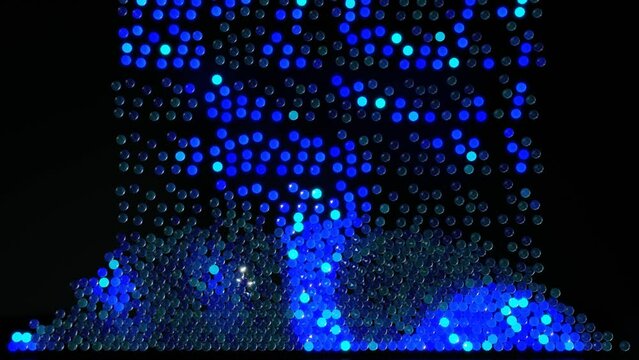 4k background blue spheres fall down and fill up screen. Balls light up and form colorful pattern on spheres. Creative motion design background with balls fill up screen
