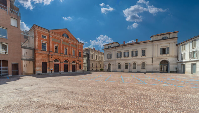 Alba, Langhe, Piedmont, Italy - August 16, 2022: cityscape of Vittorio Veneto cobblestone square with building of the Teatro Sociale (social theater) and ancient buildings