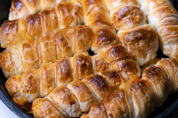 Homemade sausage roll as a snack for breakfast. Top view on baked puff pastry 