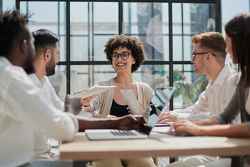 Fototapeta premium Employees working at computer together, discussing content