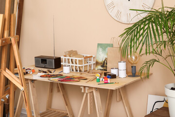 Table with artist's supplies in studio