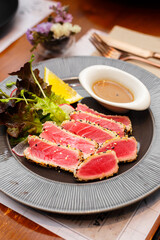 Grilled tuna salad on black plate