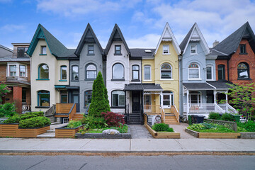Narrow Victorian row houses with peaked gables - 615603598