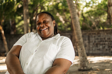 Senior black woman in the sunset beach.