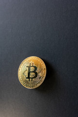 shiny gold bitcoin on black background
