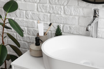 Fototapeta premium Sink bowl and bath accessories on table in bathroom, closeup