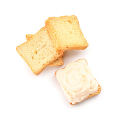 Tasty croutons with cream cheese on white background
