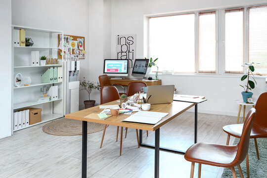 Interior of office with graphic designer's workplaces