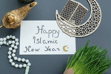 Card with text HAPPY ISLAMIC NEW YEAR, tasbih, Aladdin lamp and crescent on color background