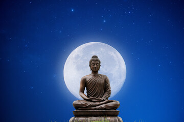 Sitting Buddha and moon on blue sky background.