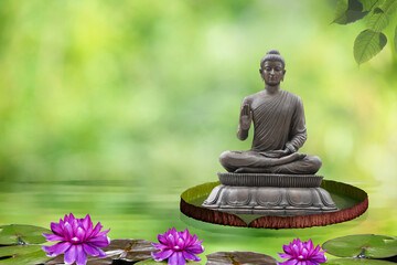 Sitting Buddha on bokeh nature background.