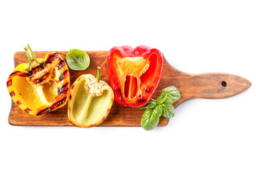 Wooden board with tasty grilled bell peppers isolated on white background