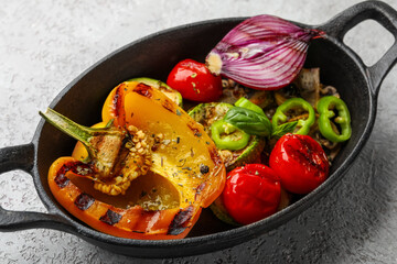Baking dish with grilled vegetables on grey background