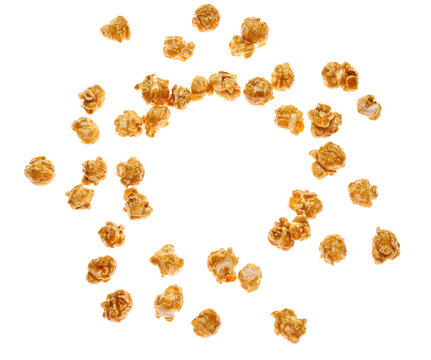 Frame made of flying tasty caramel popcorn on white background