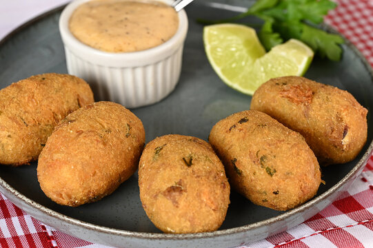 Fried codfish fritter typical Portuguese and Brazilian cuisine fish with herbs.