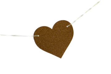 An isolated gold glitter heart on a string against a blank background