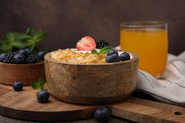 Delicious crispy cornflakes, yogurt and fresh berries in bowl on table. Healthy breakfast