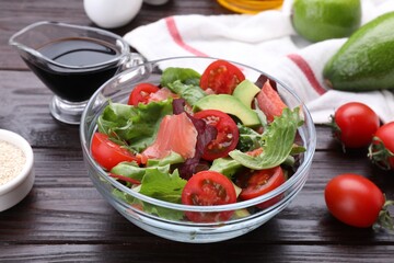 Vegetable salad with soy sauce on wooden table, closeup