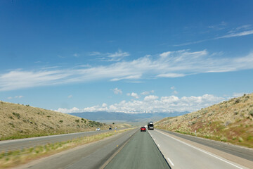 Beautiful road on a sunny day. Highway in America among the mountains. Traveling on a beautiful road. Holiday trip