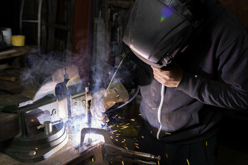 Crafting Mastery: Blacksmith Welding Metal with Precision and Focus