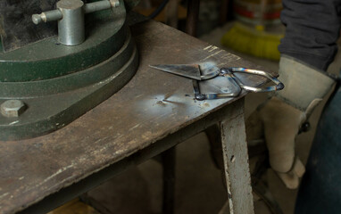 The Art of Fusion: Recently Welded Piece on Blacksmith's Workbench