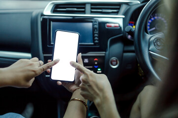 Woman holding a smartphone with white blank screen, Woman to use navigation applications in driving, copy space