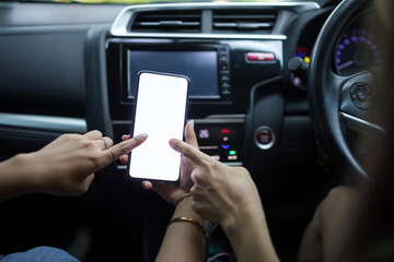 Woman holding a smartphone with white blank screen, Woman to use navigation applications in driving, copy space