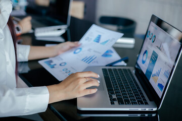 Obraz na płótnie Canvas Asian Business woman use laptop to analysis data at office
